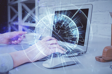 Double exposure of woman hands typing on computer and business theme hologram drawing. Success concept.