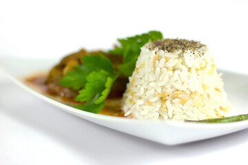 Rice pilaf and okra in a white plate