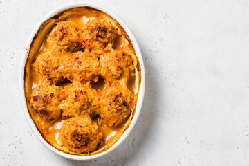 Italian turkey meatballs in a baking dish. Space for text, top view.