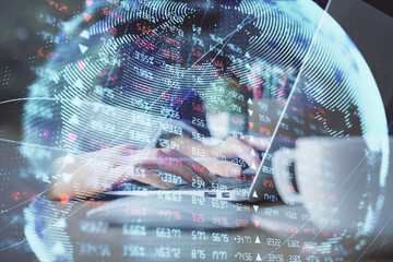 Double exposure of woman hands typing on computer and business theme hologram drawing. Success...