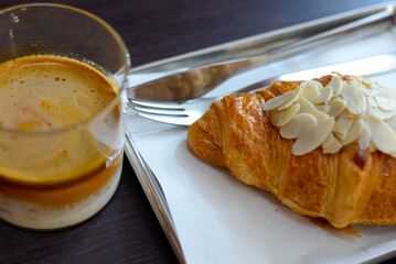 Croissant and coffee on the tray