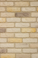 An example of facing an internal partition in a room of a house with decorative gypsum bricks with tiles in the shape of an antique wall, powder grout and colorless matte varnish