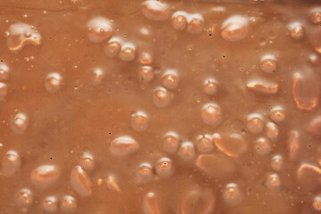 Fototapeta na wymiar Brown milk chocolate bar with nuts background.