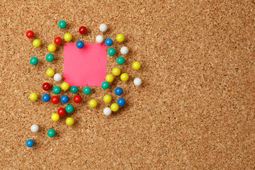 Empty color note with pushpins and blank space on cork board.