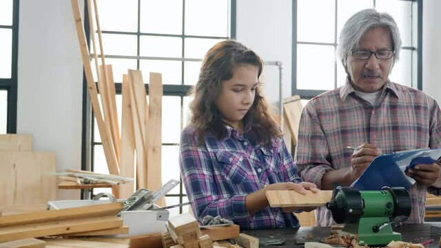 Asian family Father and daughter work in the home carpentry during the holiday. Home repair skill training activity During Work at home. Relationship Old young family. Concept Education And learn