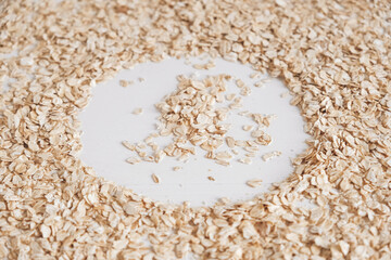Dry oatmeal scattered in the form of a circle on a white background. Copy, empty space for text