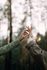the hands of a couple in love hold together