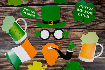 Background for St. Patrick's Day, March 17, with a festive garland, beer, leprechaun hat, clover on...
