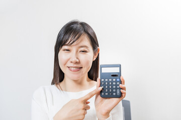 Woman pointing at a calculator with smile