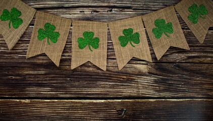 Banner. Background for St. Patrick's Day, March 17, with a festive garland of clover on a wooden...