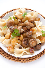 Pasta farfalle with grilled mushrooms and onions with spice, fresh parsley and onions
