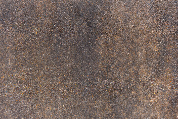 The texture of the natural stone wall has a stain on the background.