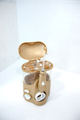 Portable Oral irrigator in the dentist's office on the table with an open lid and various attachments Blurred background