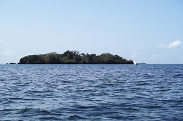 Fototapeta na wymiar Island in the sea and sailboat