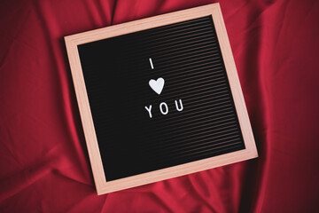 Board with the romantic message "I love you" written. Valentine's Day.