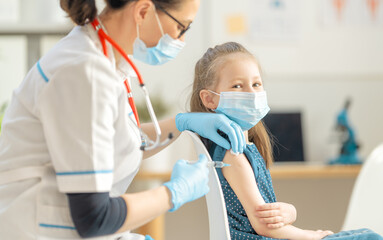 Doctor vaccinating child