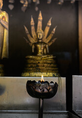 Light a candle to pay homage to the Buddha image for the birthday.