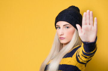 Young woman gesturing stop sign with palm of hand,refuses or reject something, isolated on white...