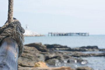 Rope with wood and sea blur background