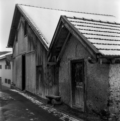 Old log huts for animal shelters in the Swiss village of Alvaneu, shot with analogue photography technique