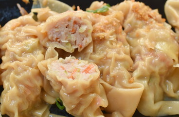 boiled dumpling or gyoza stuffed mashed pork and shrimp with vegetable topping fried chop garlic on plate dipping sweet soybean sauce
