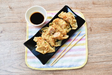 boiled dumpling or gyoza stuffed mashed pork and shrimp with vegetable topping fried chop garlic on plate dipping sweet soybean sauce