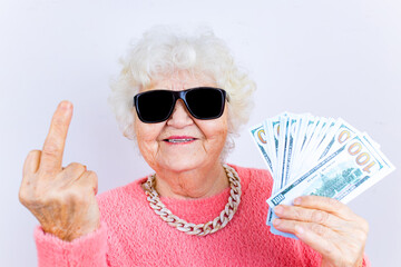 blonde old lady wear pinl sweater and sunglasses showing money isolated white background she is...