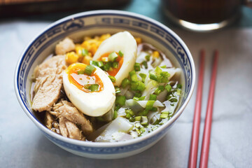 Japanese ramen noodle soup with chicken, corn, scallions, rice noodles