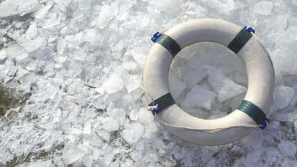 A lifebelt on the ice swimming spot at wintery beach