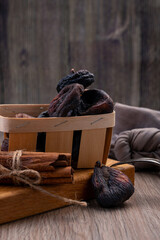 dried fruits. Dried whole figs in a wooden box on a wooden background.