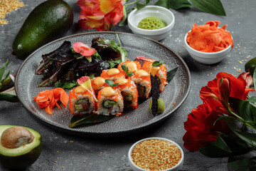 Fototapeta na wymiar Sushi Roll with salmon tuna avocado royal prawn cream cheese Philadelphia caviar tobica chuka. Sushi menu. Japanese food