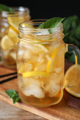 Delicious iced tea in mason jar on wooden table
