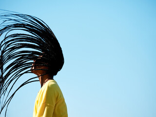 profile image of a black girl isolated, wearing casual clothes and with long hair with african braids or dreadlocks, with copy space