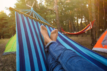 Woman resting in comfortable hammock outdoors, closeup