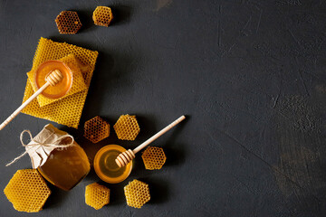 Healthy Thick honey dipping from the wooden honey spoon, bee products by organic natural...