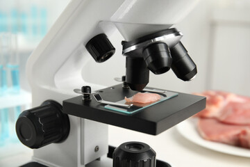 Slide with meat sample on microscope in laboratory, closeup. Poison detection