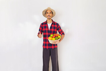 Farmer black man with hat and gloves holding a basket of vegetables isolated