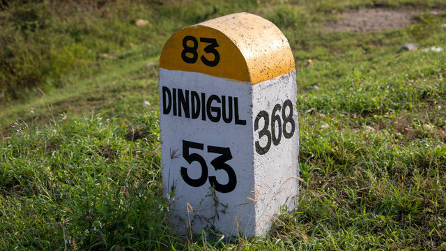 Beautiful Road sign in White and Yellow Coloured on the side of Dindigul to Trichy City National Highways kept by Transport Department of Indian Government in Tamilnadu - NH 83 Road Kilometre Stone