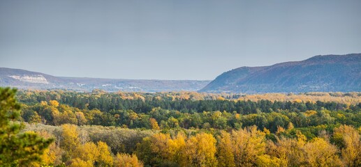 Aerial landscape view over colorful green and orange autumn forest in countryside in Samara region, Russia