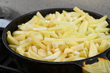 Homemade fried potatoes on pan. Close-up.