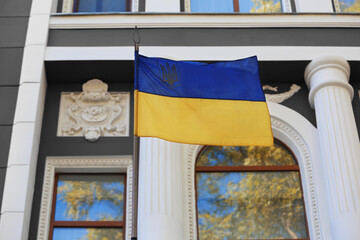 National flag of Ukraine on vintage building wall outdoors