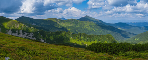 Fototapeta na wymiar Summer mountain slope with picturesque rock formations. Shpyci mountain, Carpathian, Ukraine.