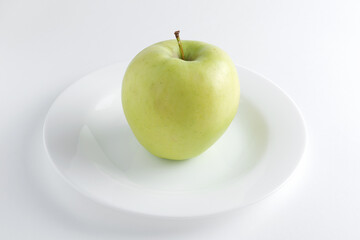 Green apple on a plate