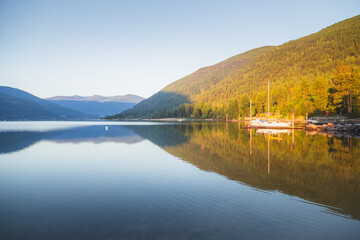 A beautiful, calm summer morning at sunrise on Kootenay Lake with views of Nelson, B.C., Canada.