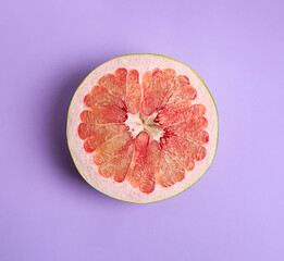 Fresh cut pomelo fruit on lilac background, top view