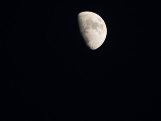 a close up of a crescent moon with its craters at night