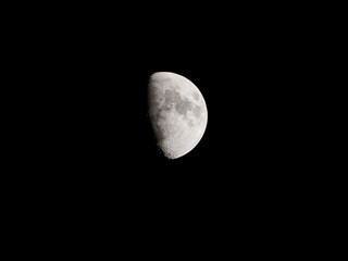 a close up of a crescent moon with its craters at night