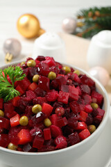 Traditional Russian salad vinaigrette in bowl, closeup