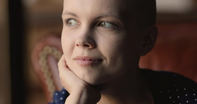 Attractive young hairless woman looking at camera, motivated optimistic oncology disease cancer patient close up portrait. Successful treatment, remission, optimism and hope in full recovery concept