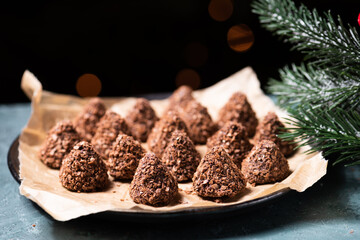 Truffle chocolate candies with assorted wafer crumbs. Sweet homemade dessert on a plate